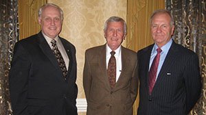 three elderly men posing in suits