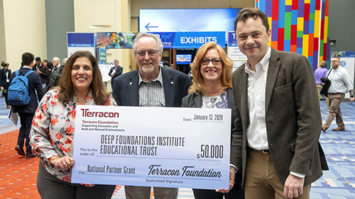 2 men and 2 women holding a giant check